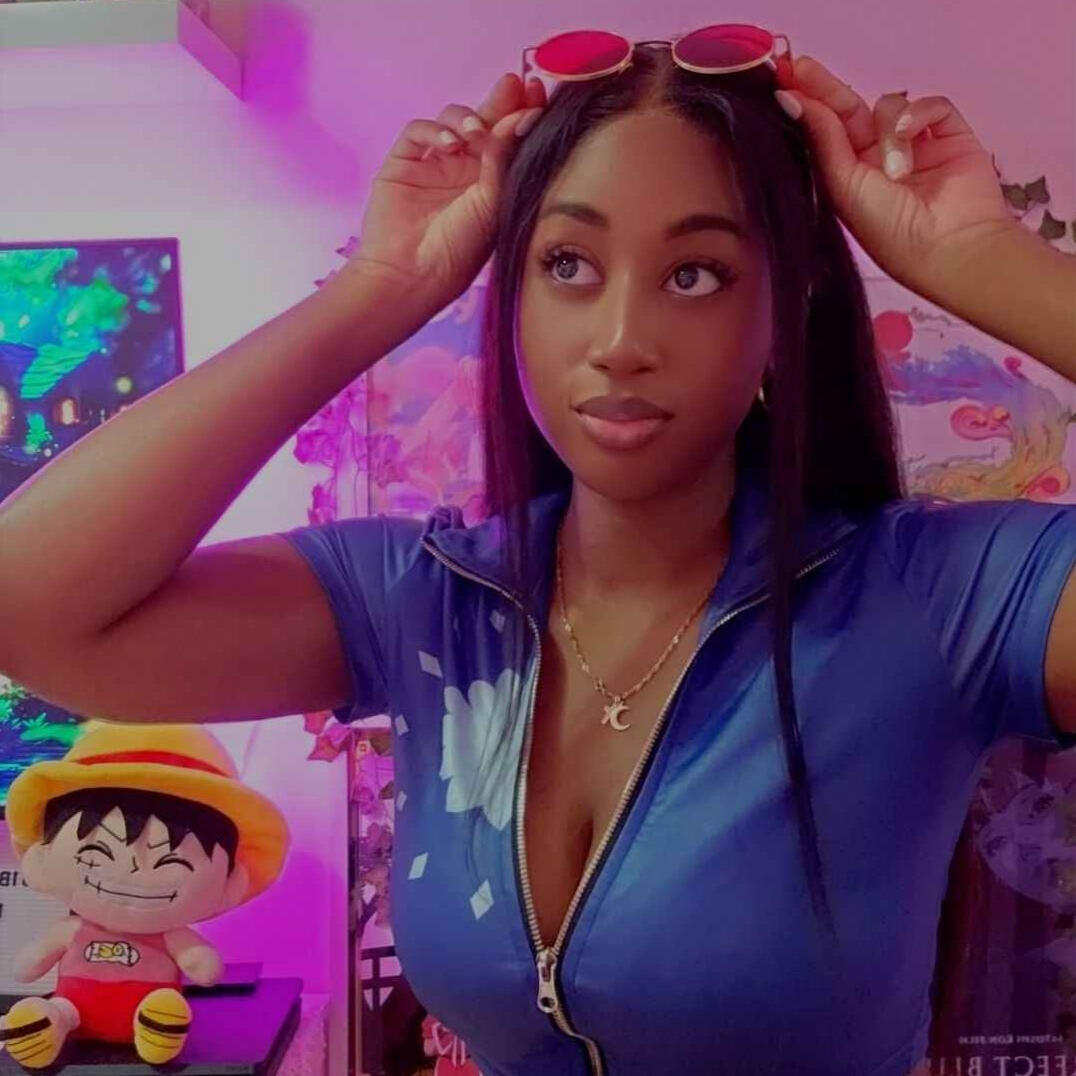 A blushing brunette chibi drawing with 3c curly hair, pink and red highlights, they have circle eyebrows red and pink eyes and low hanging jeans with peach boxers and red sports top. The background are shades of teal and green drawing a painterly/sketchy b